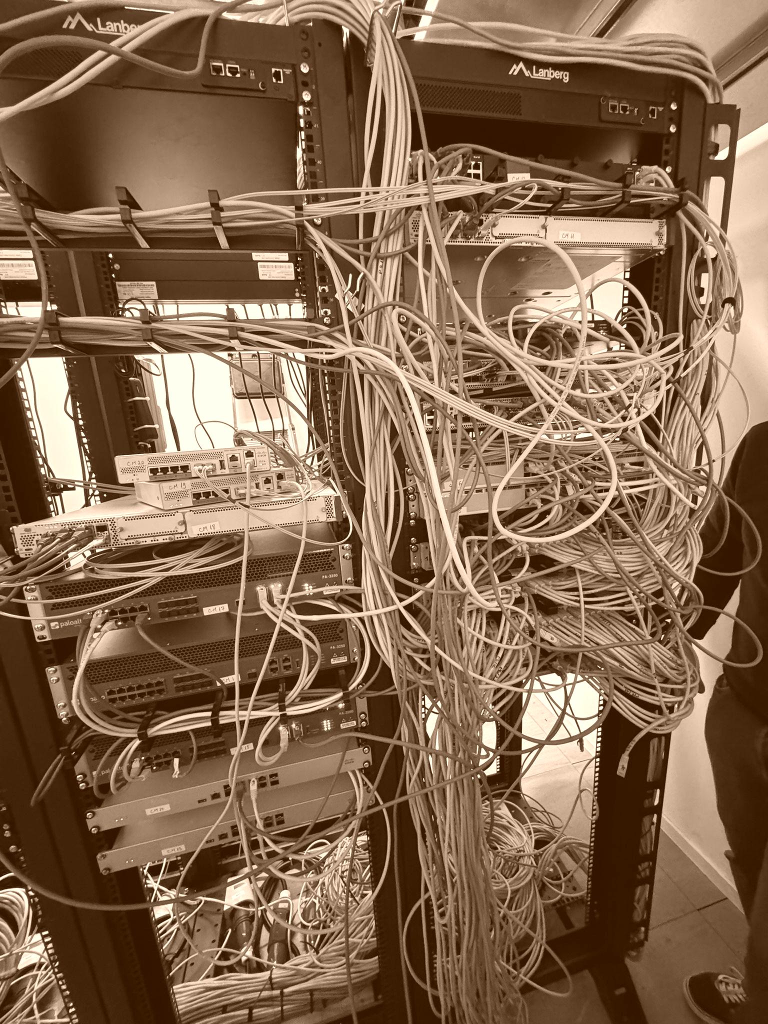 Messy server rack cabling before professional cable management in a data centre.